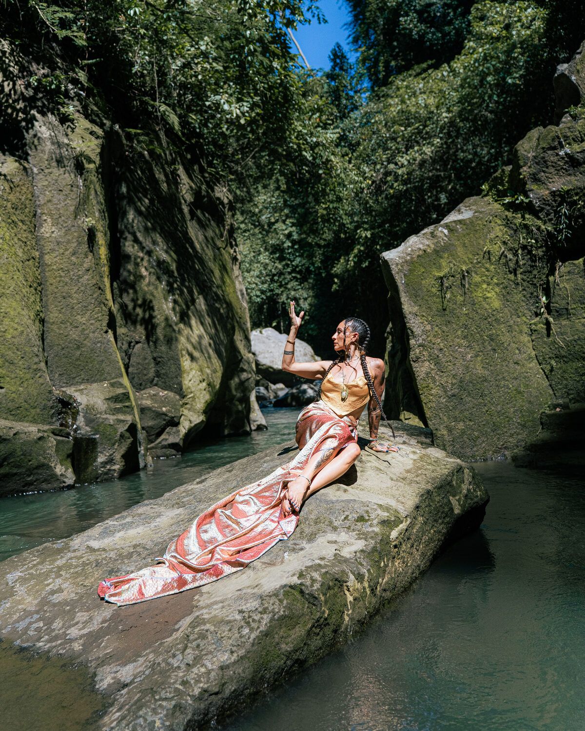 TIHANE reclining on a river rock
