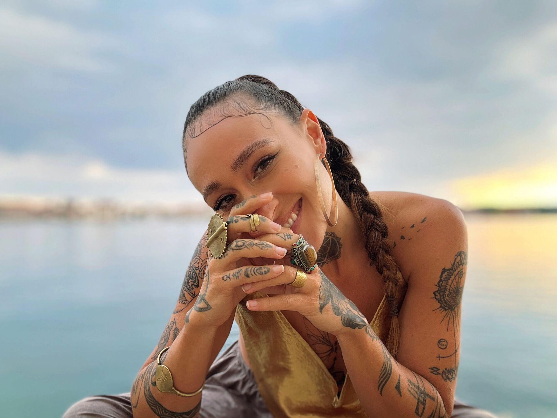TIHANE smiling by the water