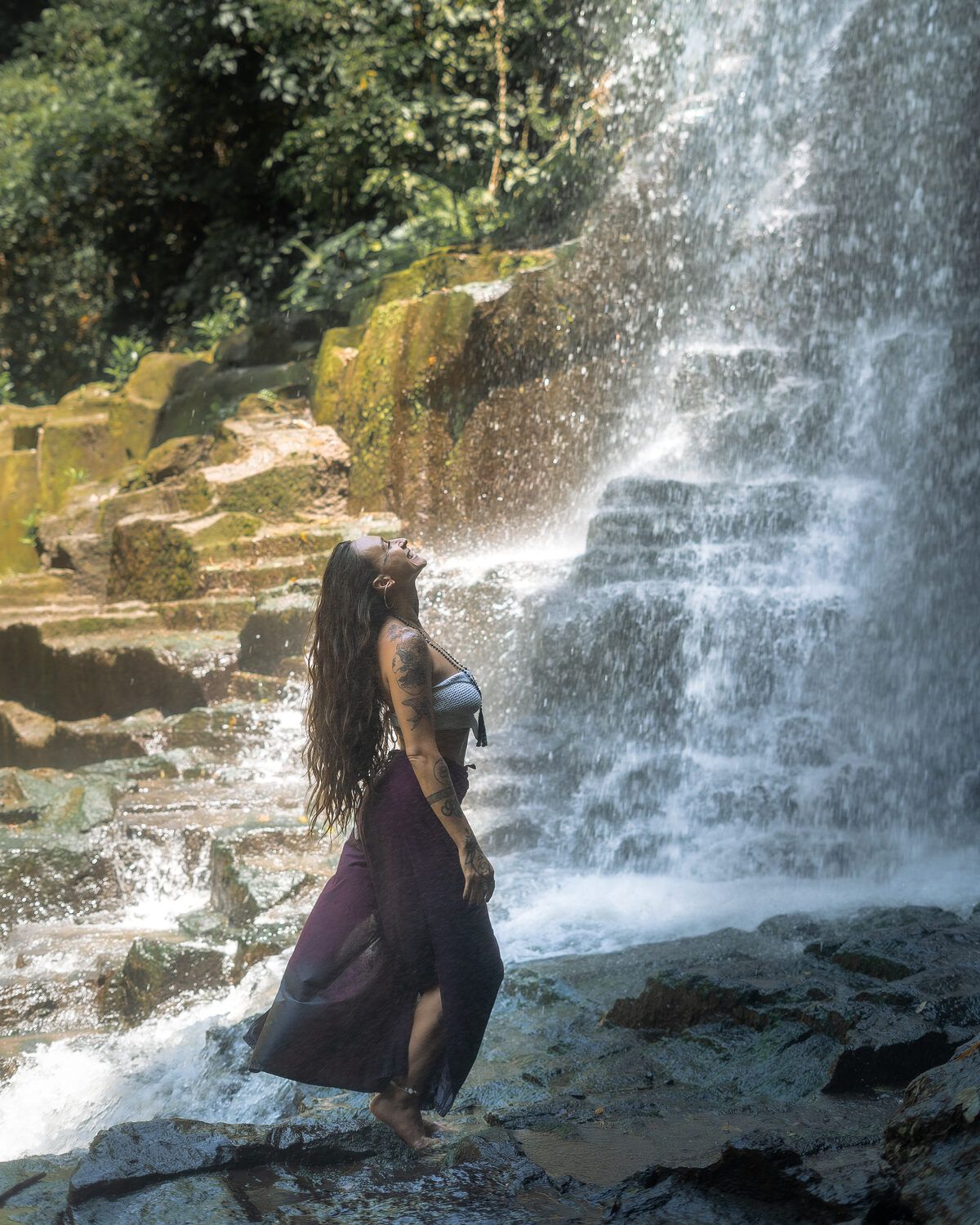 TIHANE smiling up into waterfall light